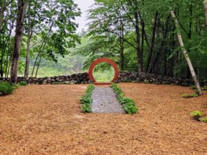 Wedding ceremony space with a moongate between a rock wall